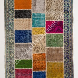 May include: A rectangular patchwork rug featuring a variety of colourful fabric squares in orange, black, beige, blue, grey, green, yellow, and magenta. The rug is bordered by a dark blue and light blue patterned frame with the text BespokeHandmadeRugs.
