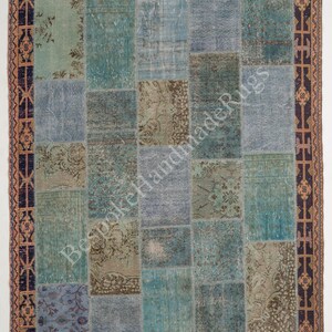 May include: A rectangular patchwork rug featuring various shades of blue, teal, and muted brown. The rug is composed of stitched fabric segments with floral and geometric patterns, framed by a dark blue and orange border with the text BespokeHandmadeRugs.