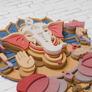 May include: A multi-layered wooden wall art piece depicting the deity Ganesha. The design features stacked, laser-cut wood segments in shades of natural light wood, soft pink, deep red, and blue, forming a complex, three-dimensional floral pattern.