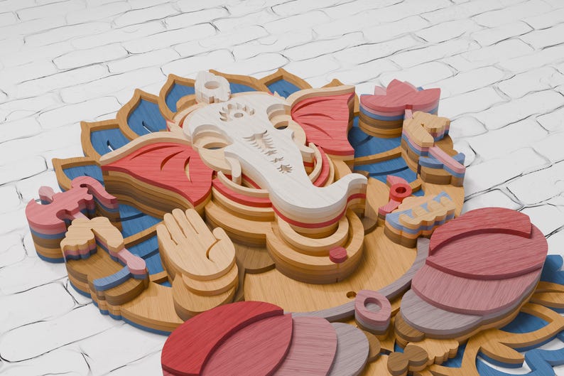 May include: A multi-layered wooden wall art piece depicting the deity Ganesha. The design features stacked, laser-cut wood segments in shades of natural light wood, soft pink, deep red, and blue, forming a complex, three-dimensional floral pattern.
