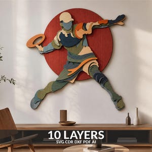 May include: A multi-layered wooden wall art piece featuring a stylized athlete in a dynamic throwing pose, set against a large red circular background. The figure is composed of ten distinct layers in shades of blue, green, orange, and tan.