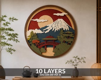 May include: A circular multi-layered wooden wall art piece featuring a landscape with a snow-capped mountain, a red arched bridge, and stylised trees. The design includes a large sun against a red background, with white clouds and 10 layers of depth.
