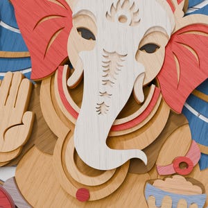 May include: A multi-layered wooden wall art piece depicting the deity Ganesha. The design features stacked laser-cut wood panels in shades of natural light wood, white, coral red, and blue, creating a three-dimensional relief effect of the figure.