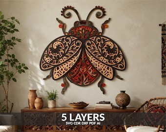 May include: A multi-layered wooden wall art piece shaped like a beetle, featuring intricate laser-cut floral patterns in black, natural wood, and orange tones. The design consists of 5 layers, with text at the bottom reading 5 LAYERS SVG CDR DXF PDF AI.