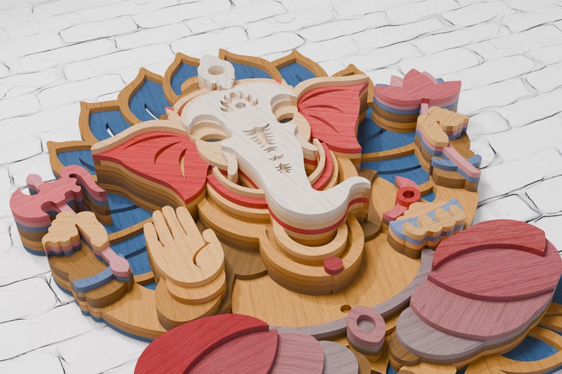 May include: A multi-layered wooden wall art piece depicting the deity Ganesha. The design features stacked laser-cut wood elements in shades of natural light wood, soft pink, deep red, and blue, creating a three-dimensional relief effect.