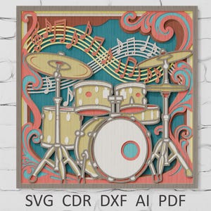 May include: A layered wooden art piece featuring a drum set with cymbals and musical notes. The design incorporates shades of yellow, teal, and coral, with a decorative border. The bottom of the image displays the text "SVG CDR DXF AI PDF".