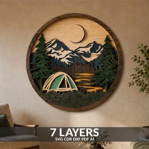 May include: A circular multi-layered wooden wall art piece featuring a mountain landscape with a crescent moon, evergreen trees, and a tent. The design uses various wood tones including dark brown, green, and natural light wood finishes.
