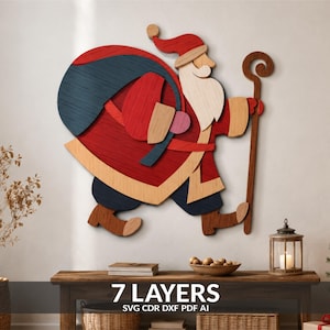 May include: A multi-layered wooden wall art piece depicting Santa Claus carrying a large dark blue sack over his shoulder while holding a wooden staff. The design features seven distinct layers in red, blue, tan, and brown wood tones.