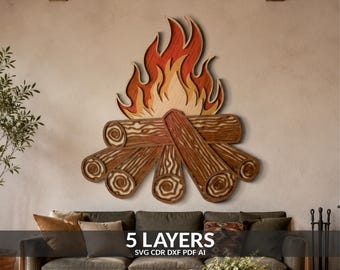 May include: A multi-layered wooden wall art piece depicting a campfire with stylized logs and flames. The design features five distinct layers of wood in shades of brown, orange, and yellow, showcasing wood grain textures and flame silhouettes.