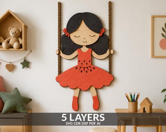 May include: A multi-layered wooden wall art piece depicting a girl with black hair and red hair bows sitting on a swing. The girl wears a red dress with a watermelon seed pattern. The text 5 LAYERS SVG CDR DXF PDF AI is printed at the bottom.