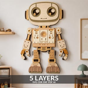 Puede incluir: Una pieza de arte mural de madera multicapa con forma de robot, con una cabeza grande, ojos circulares y un torso rectangular con varios recortes geométricos. El texto 5 LAYERS SVG CDR DXF PDF AI está impreso en la parte inferior.