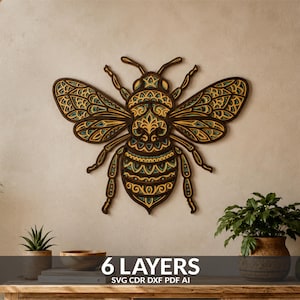 May include: A multi-layered wooden wall art piece shaped like a bee, featuring intricate laser-cut patterns in shades of dark brown, yellow, and teal. The design consists of 6 layers, and the text 6 LAYERS SVG CDR DXF PDF AI is visible.