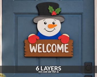 May include: A snowman door sign featuring a black top hat with green holly and red berries, a blue scarf, and red mittens. The snowman holds a brown wooden-style sign with the white text WELCOME. The image includes the text 6 LAYERS SVG CDR DXF PDF AI.