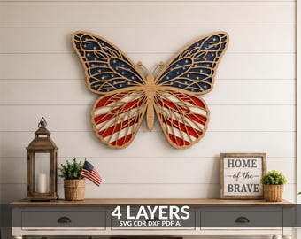 May include: A multi-layered wooden butterfly wall art piece featuring a cutout design. The upper wings display a dark blue background with white stars, while the lower wings feature red and white stripes, mimicking the American flag pattern.