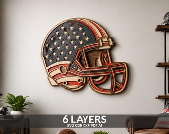 May include: A multi-layered wooden wall art piece shaped like a football helmet. The design features a dark blue section with cut-out stars and red and natural wood stripes. The helmet has a prominent face mask and a layered, dimensional structure.