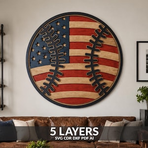 May include: A circular wooden wall art piece featuring a layered design of a baseball with red, white, and blue American flag patterns. The artwork includes black stitching details and the text 5 LAYERS SVG CDR DXF PDF AI at the bottom.