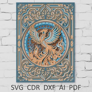 May include: A layered wooden art piece featuring a phoenix rising from flames. The design incorporates intricate patterns and a color palette of teal, brown, and blue. The text "SVG CDR DXF AI PDF" is at the bottom.