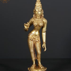 May include: A golden statue of a female figure, adorned with intricate details. The statue features a tall headdress, ornate jewelry, and flowing garments. It stands on a lotus flower base, exuding a sense of grace and spirituality. The figure's pose suggests movement.