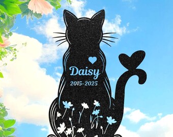 May include: Black metal cat silhouette garden stake with the name "Daisy", a heart, and the years 2015-2025 in blue. Features a tail shaped like a butterfly and white flower accents.