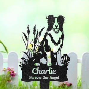 May include: Black and white metal garden stake with a Border Collie design. The stake has the name "Charlie" and the phrase "Forever Our Angel". The dog is depicted in a grassy area with tall grass and mushrooms.