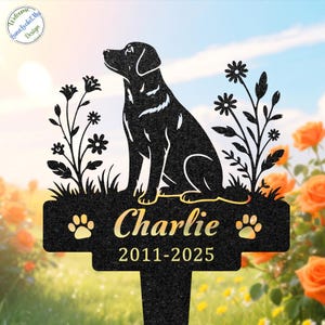 May include: A black metal garden stake featuring a silhouette of a sitting dog flanked by floral stems. The design includes the name Charlie and the years 2011-2025, with a paw print icon on each side of the name. The text LunaLocketMyDesign is visible.