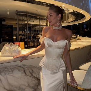 Satin corset with molded cups and adjustable straps paired with long flowing maxi skirt with side slit, high waist, elegant two-piece outfit for evening or special occasion