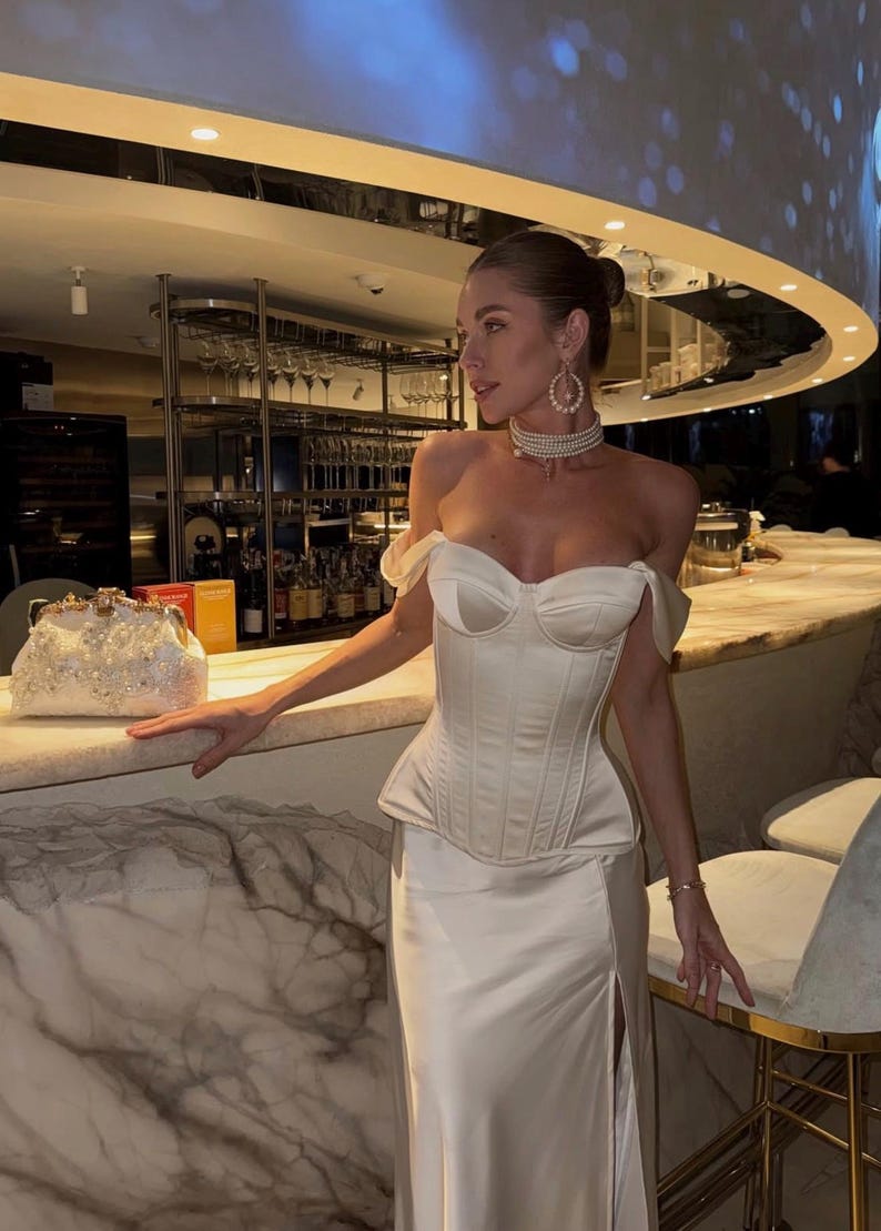 Satin corset with molded cups and adjustable straps paired with long flowing maxi skirt with side slit, high waist, elegant two-piece outfit for evening or special occasion