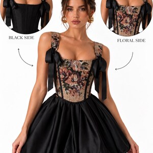 May include: A reversible corset dress featuring a floral print side and a solid black side. The bodice has square straps with black ribbon bows. The skirt is a black, voluminous bubble style. Text labels indicate BLACK SIDE and FLORAL SIDE.