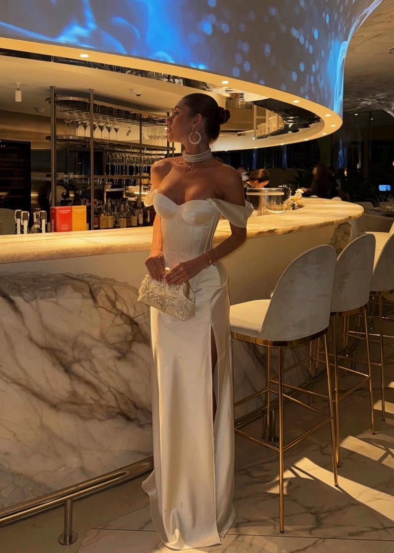 Satin corset with molded cups and adjustable straps paired with long flowing maxi skirt with side slit, high waist, elegant two-piece outfit for evening or special occasion