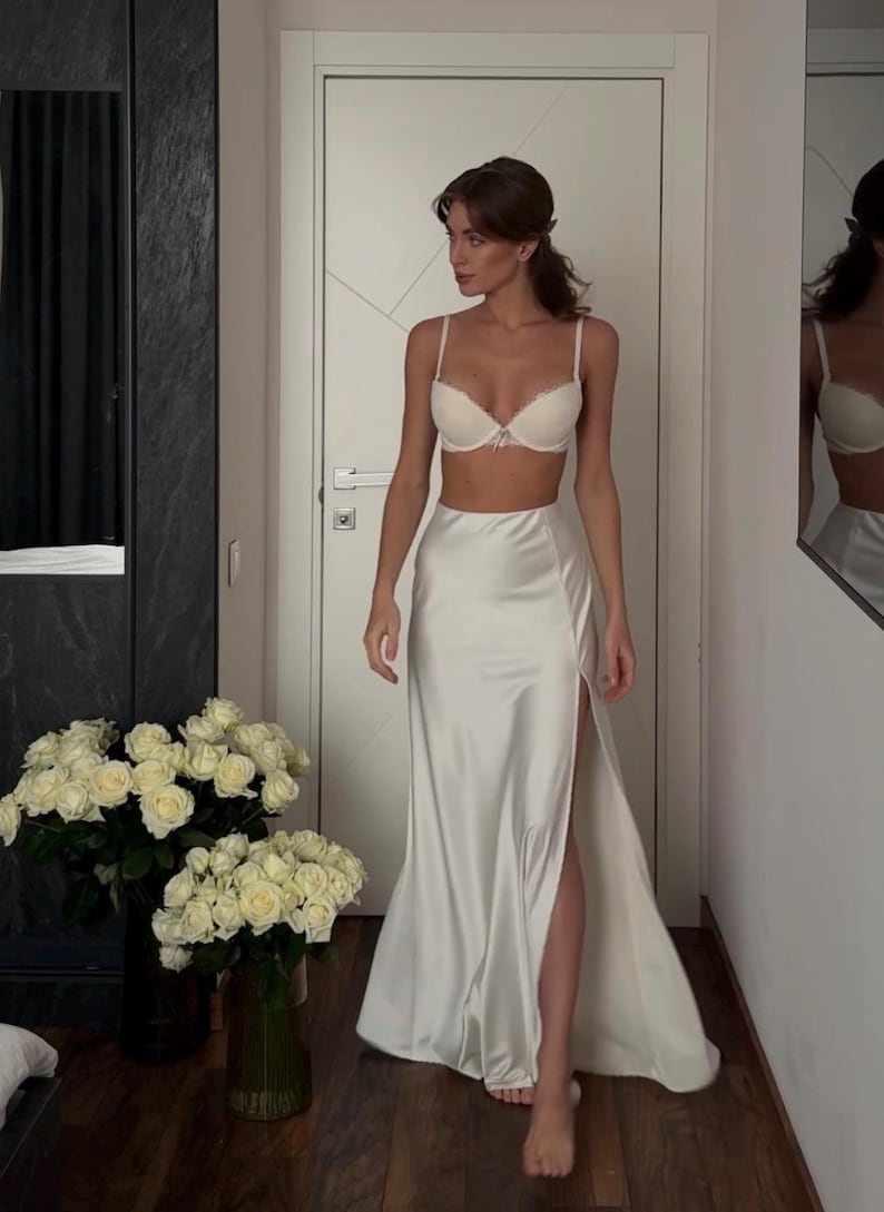 Satin corset with molded cups and adjustable straps paired with long flowing maxi skirt with side slit, high waist, elegant two-piece outfit for evening or special occasion
