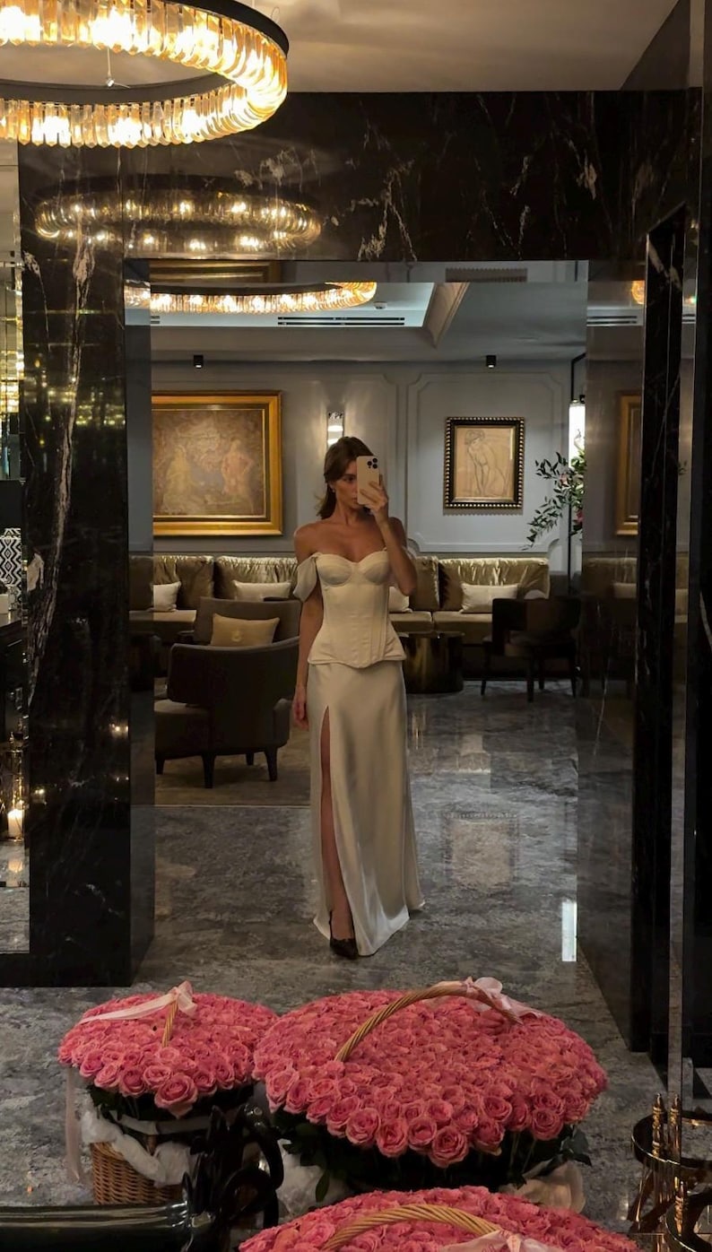 Satin corset with molded cups and adjustable straps paired with long flowing maxi skirt with side slit, high waist, elegant two-piece outfit for evening or special occasion