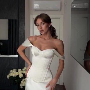 Satin corset with molded cups and adjustable straps paired with long flowing maxi skirt with side slit, high waist, elegant two-piece outfit for evening or special occasion