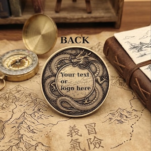May include: A round, antique-finish brass coin featuring an embossed dragon encircling a central blank circular area with the text "Your text or logo here". The word "BACK" is printed above the coin, which rests on a map-patterned surface.