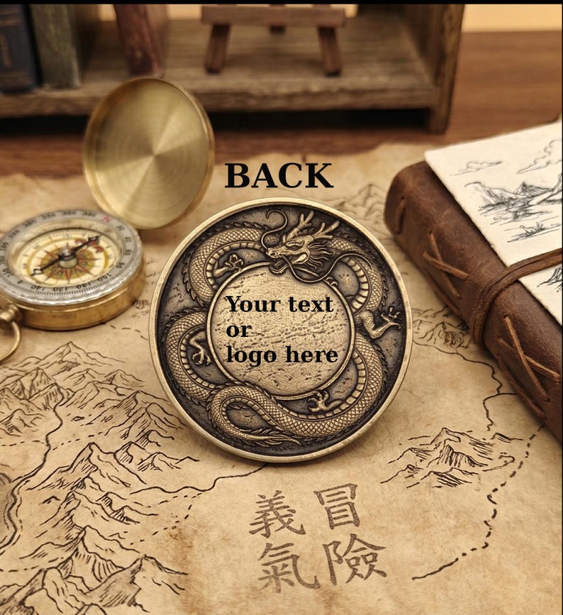 May include: A round, antique-finish brass coin featuring an embossed dragon encircling a central blank circular area with the text "Your text or logo here". The word "BACK" is printed above the coin, which rests on a map-patterned surface.