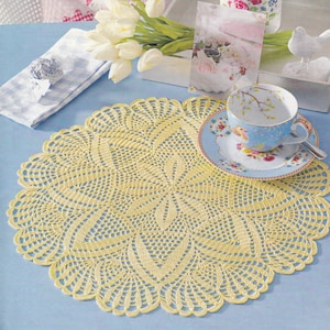 May include: A yellow crocheted doily with a delicate floral pattern, perfect for adding a touch of elegance to any table setting.