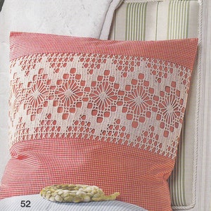 Può includere: Un cuscino a quadri rossi e bianchi con un bordo in pizzo bianco. Il cuscino è appoggiato su una sedia a righe bianche e verdi.