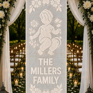 May include: A rectangular white crochet wall hanging featuring a central graphic of a cherub holding a flower, surrounded by floral motifs at the top and bottom, with the text THE MILLERS FAMILY clearly woven into the center of the fabric design.