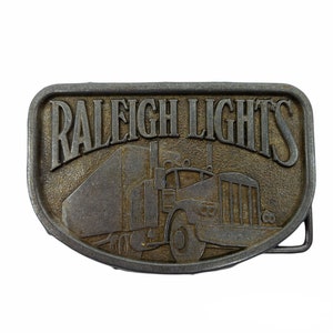 Vintage Raleigh Lights Belt Buckle Metal Trucker Semi Truck 18 Wheeler