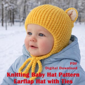 May include: A yellow knitted baby hat with earflaps and ties. The hat is made of a soft, textured yarn and has small, beige-colored ear details. The hat is worn by a baby wearing a blue jacket. Text on the image reads "Knitting Baby Hat Pattern Earflap Hat with Ties".