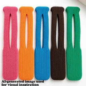 May include: Five colorful, knitted hair accessories in pink, orange, blue, brown, and green. Each has a long, rectangular shape with a central opening. The text at the bottom reads "AI-generated image used for visual inspiration."