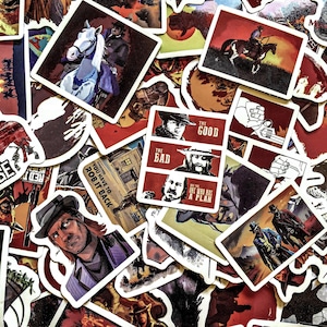 May include: A collection of Western-themed stickers with illustrations of cowboys, horses, and text. The stickers feature a variety of designs, including portraits, action scenes, and text like "The Good, The Bad, and The One Who Has A Plan."