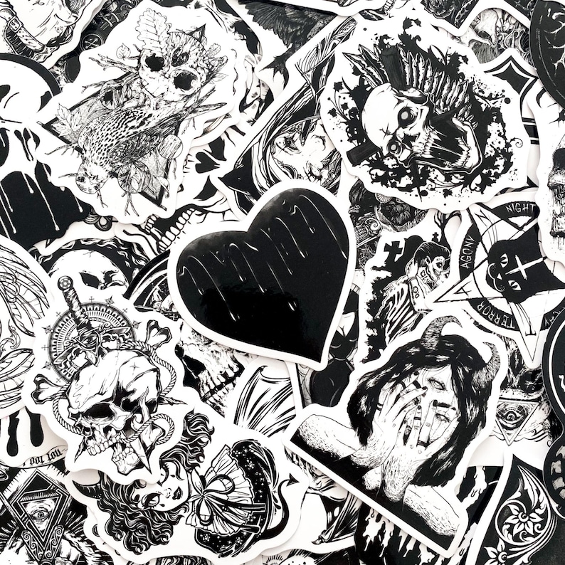 May include: A collection of black and white stickers with gothic and occult themes. Designs include skulls, hearts, demons, and other dark imagery. The stickers are of various shapes and sizes, with intricate details.
