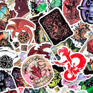 May include: A collection of colorful stickers featuring fantasy-themed designs. Dragons, dice, and text elements like "Sorcerer" and "Let Me Spell It Out" are visible. The stickers are in various shapes and sizes, with a mix of red, green, and black.