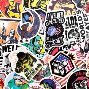 May include: A collection of colorful stickers featuring welding-themed designs. The stickers showcase welders, welding masks, sparks, and text like "A Welder Melted My Heart" and "Danger Overload". The designs incorporate red, blue, and yellow.