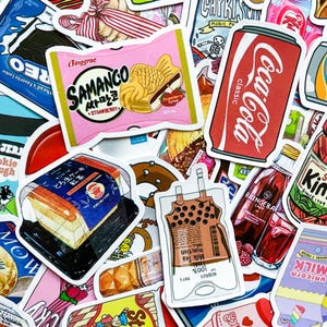 May include: A collection of colorful stickers featuring various food and beverage items. Notable stickers include a pink package of Samanco strawberry ice cream, a Coca-Cola can, and a package of Japanese cake.
