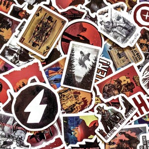May include: A collection of assorted stickers with a Western theme. The stickers feature illustrations of cowboys, playing cards, and text like "Be Loyal to What Matters" and "Red Redemption". The color palette includes red, brown, and black.