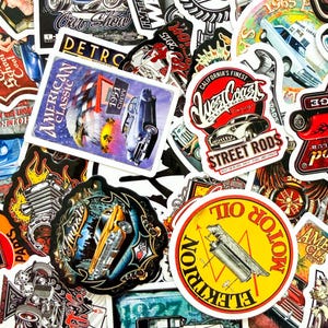 May include: A collection of vintage-style stickers featuring classic cars, hot rods, and automotive-themed designs. The stickers showcase various colors, including red, yellow, blue, and black, with text such as "American Classic" and "Motor Oil".
