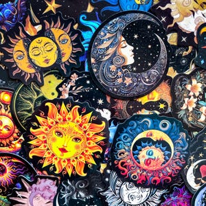 May include: A selection of celestial-themed stickers, including suns, moons, and stars. The stickers display vibrant colours and intricate details in various artistic styles. Designs include a sun with a smiling face, a crescent moon with a woman's profile, and floral accents.