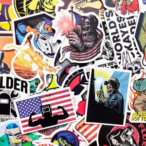 May include: A collection of stickers featuring welding-themed designs. The stickers showcase illustrations of welders, skulls, American flags, and welding sparks. The color palette includes red, white, blue, black, and yellow.