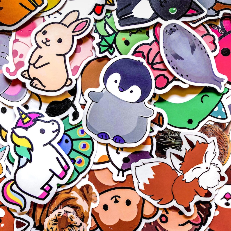 May include: A collection of colorful stickers featuring various animals. Includes a light brown bunny, a gray penguin, a white unicorn with a rainbow mane, and a brown fox. Other stickers include a seal, a tiger, and a monkey.